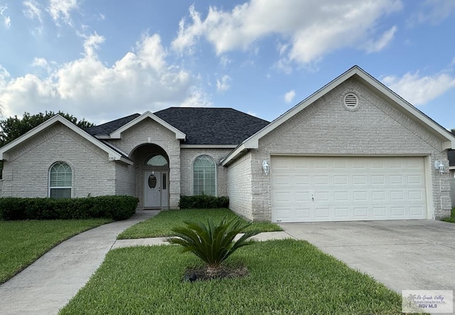 ranch-style home with a garage and a front yard