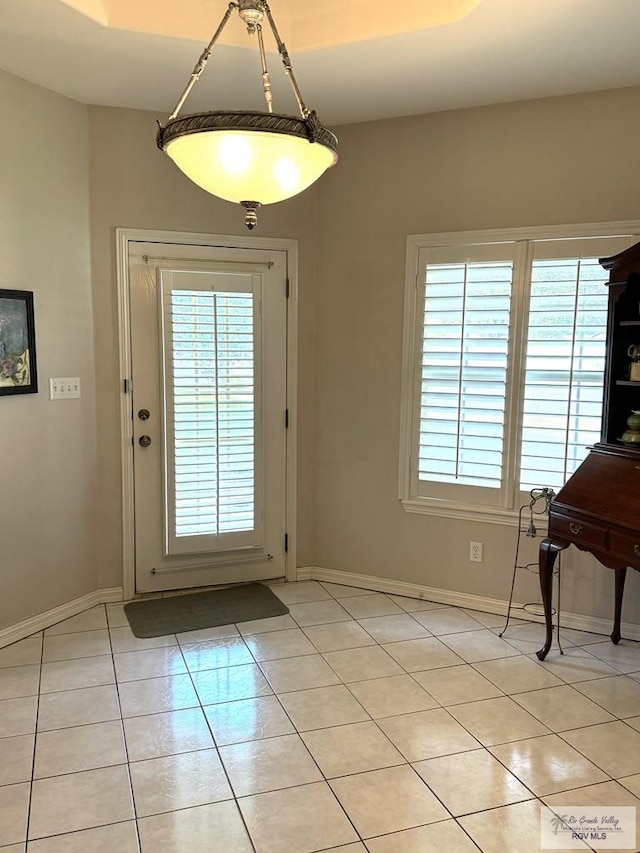 doorway featuring a wealth of natural light and light tile patterned flooring