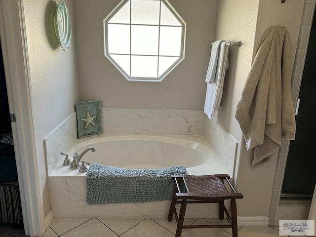 bathroom featuring a bathing tub and tile patterned flooring