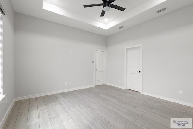 9484 S Queen Palm, Los Fresnos, TX 78566 - empty room featuring a ceiling fan, a tray ceiling, wood finished floors, and recessed lighting