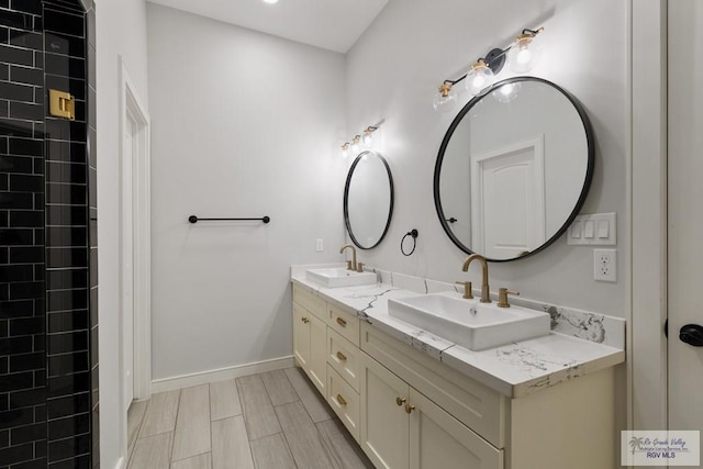 9484 S Queen Palm, Los Fresnos, TX 78566 - bathroom featuring double vanity and baseboards