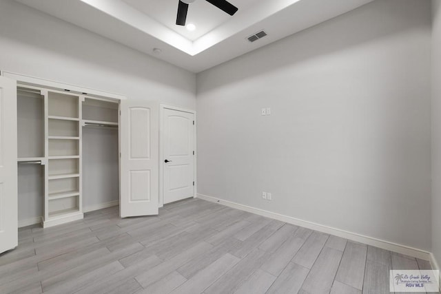 9484 S Queen Palm, Los Fresnos, TX 78566 - unfurnished bedroom with wood finished floors, a closet, a raised ceiling, a ceiling fan, and recessed lighting