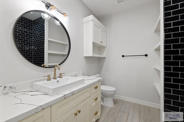 bathroom with vanity, hardwood / wood-style flooring, and toilet