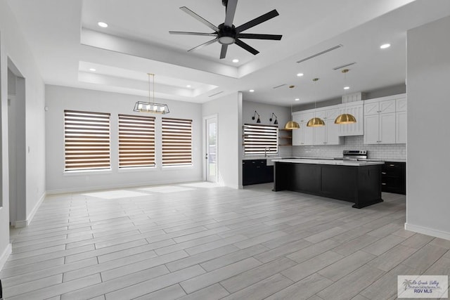 9484 S Queen Palm, Los Fresnos, TX 78566 - kitchen with electric range, open floor plan, a kitchen island, light countertops, and ceiling fan