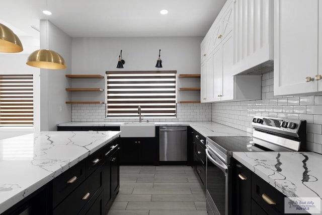 9484 S Queen Palm, Los Fresnos, TX 78566 - kitchen with appliances with stainless steel finishes, open shelves, dark cabinets, white cabinets, and recessed lighting