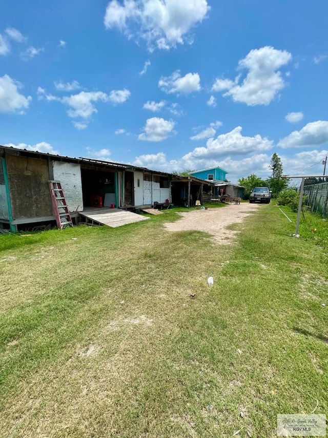 23362 Fm 506, Santa Rosa, TX 78593 - rear view of house featuring a lawn and dirt driveway