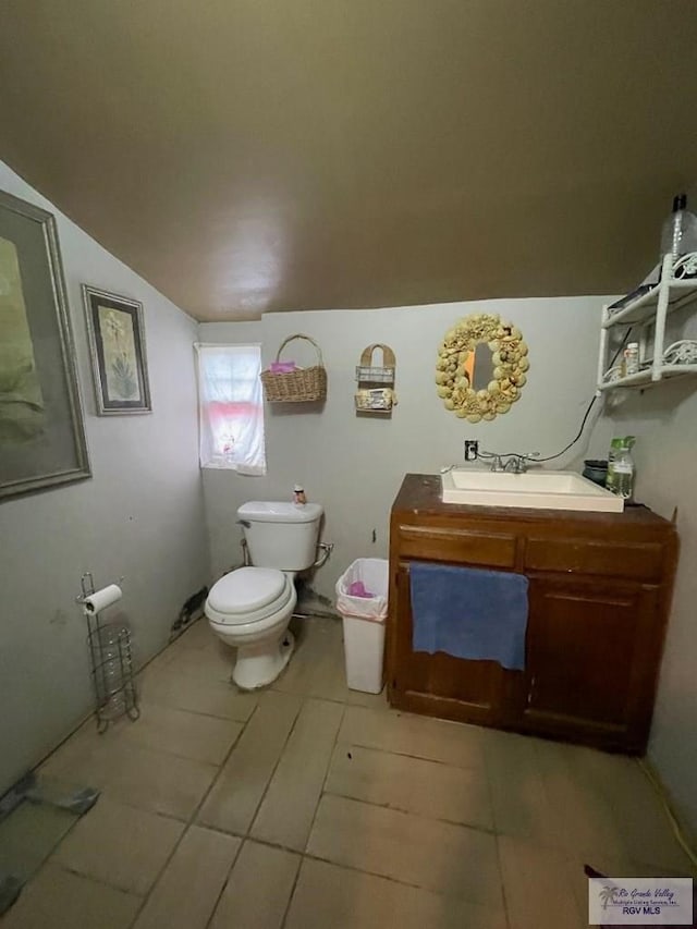 23362 Fm 506, Santa Rosa, TX 78593 - half bath featuring toilet, vaulted ceiling, tile patterned floors, and vanity