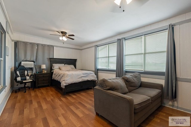 bedroom with hardwood / wood-style floors and ceiling fan