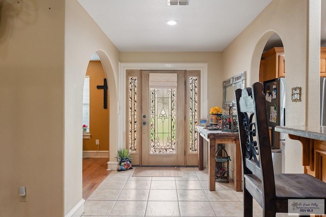 entryway featuring light tile patterned floors and plenty of natural light