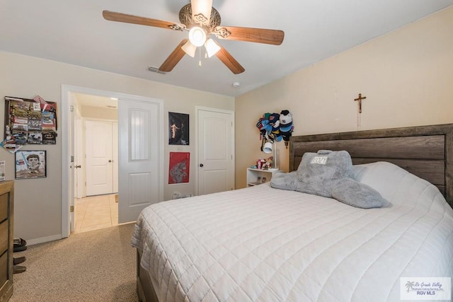 bedroom with light carpet and ceiling fan