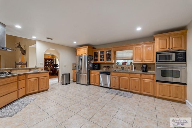 kitchen with stainless steel appliances, sink, light tile patterned floors, and backsplash