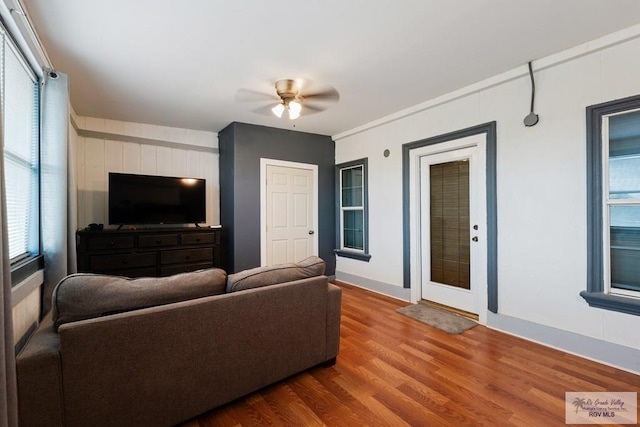 living room with a healthy amount of sunlight, ceiling fan, and wood-type flooring