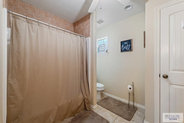 bathroom with tile patterned flooring, curtained shower, and toilet