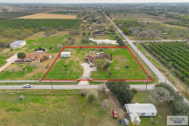 birds eye view of property with a rural view