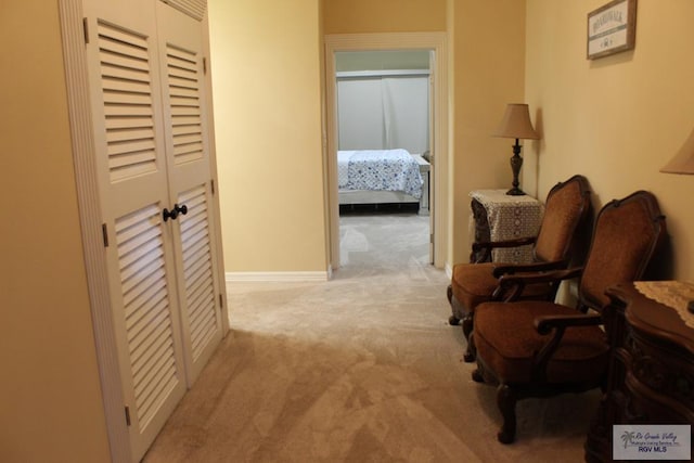 hallway with light colored carpet