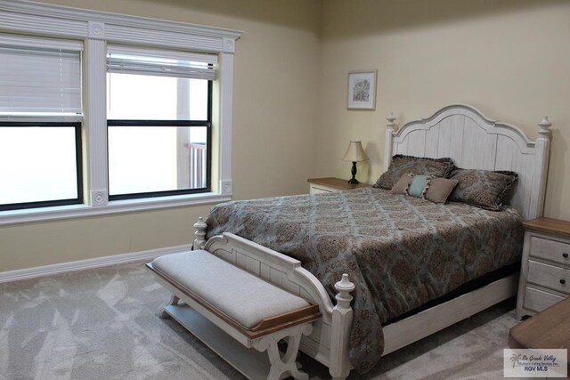 bedroom featuring light colored carpet