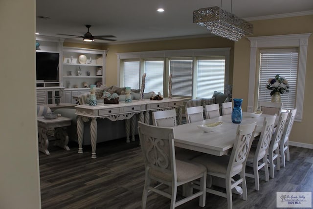 dining area with ceiling fan with notable chandelier, crown molding, and dark wood-type flooring