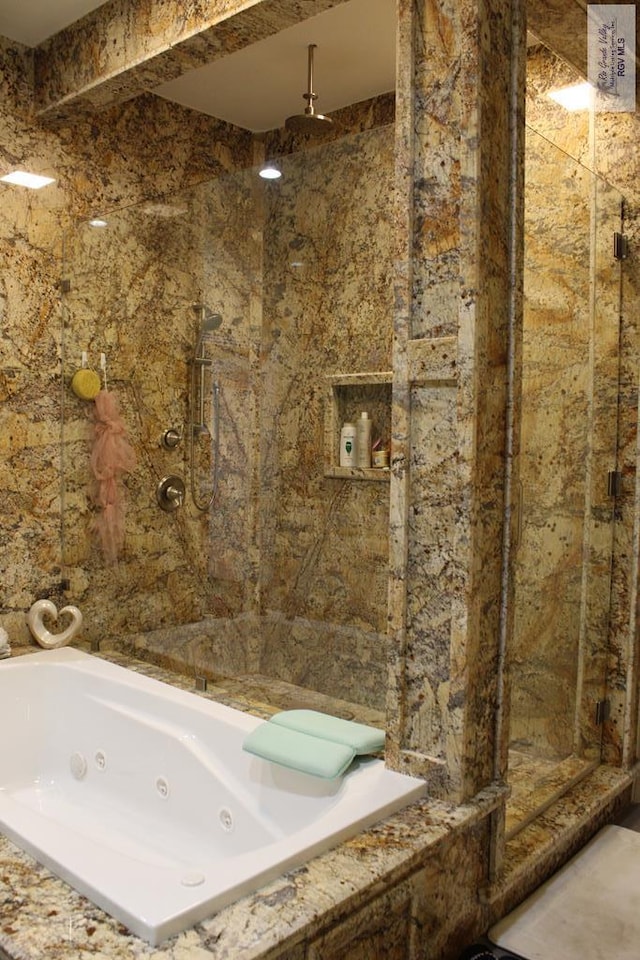 bathroom featuring separate shower and tub