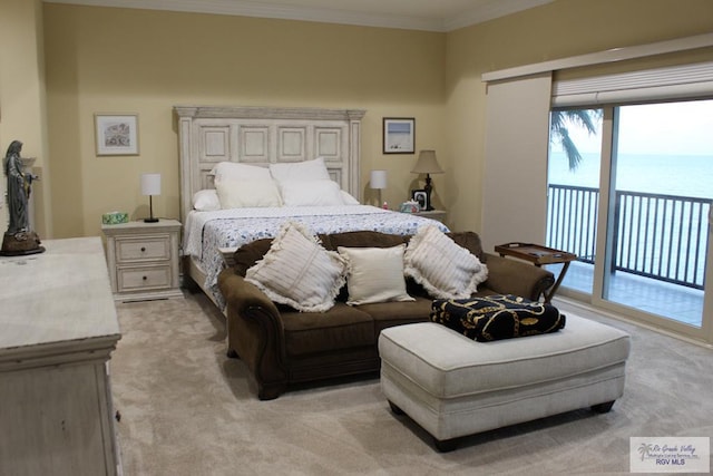 carpeted bedroom with access to exterior, a water view, and crown molding