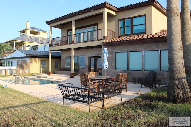 back of house with a patio area and a balcony