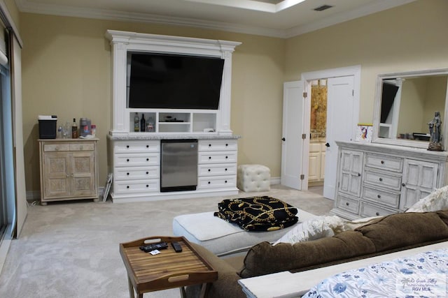 bedroom with stainless steel fridge, light colored carpet, ornamental molding, and connected bathroom