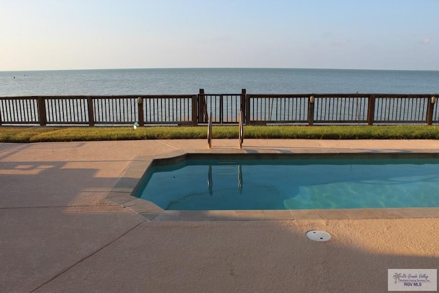 view of swimming pool featuring a water view