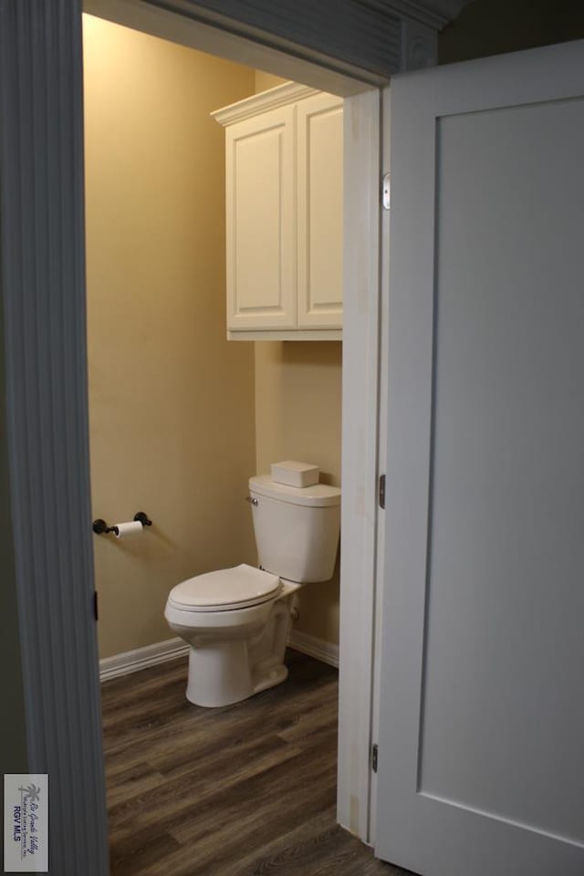 bathroom with hardwood / wood-style floors and toilet