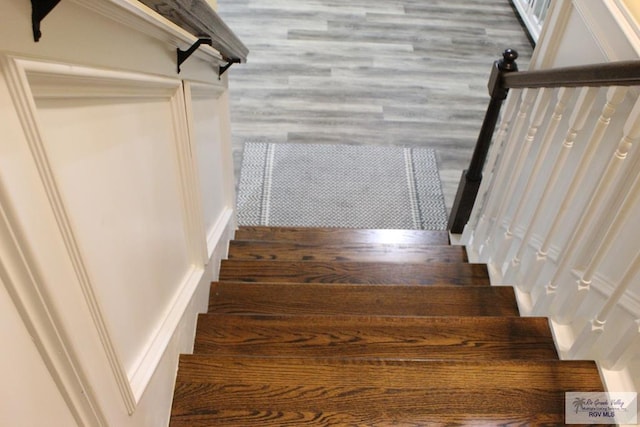 staircase featuring wood-type flooring