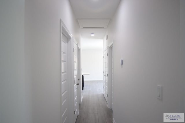 corridor with hardwood / wood-style floors