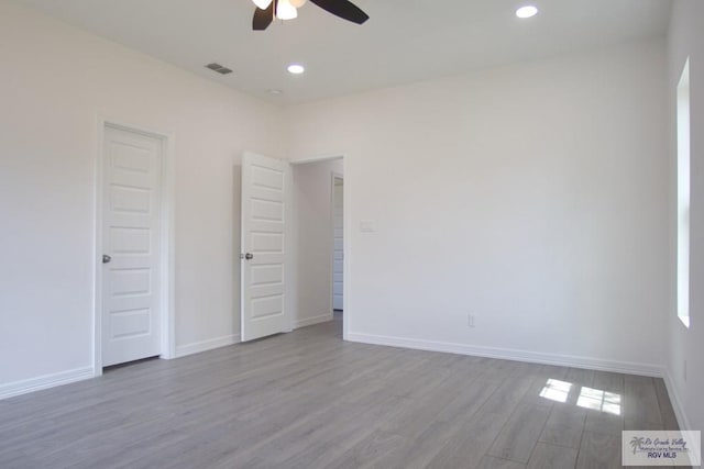 unfurnished room featuring ceiling fan and light wood-type flooring