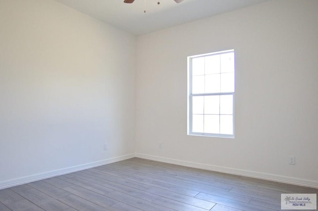 empty room featuring ceiling fan and light hardwood / wood-style floors