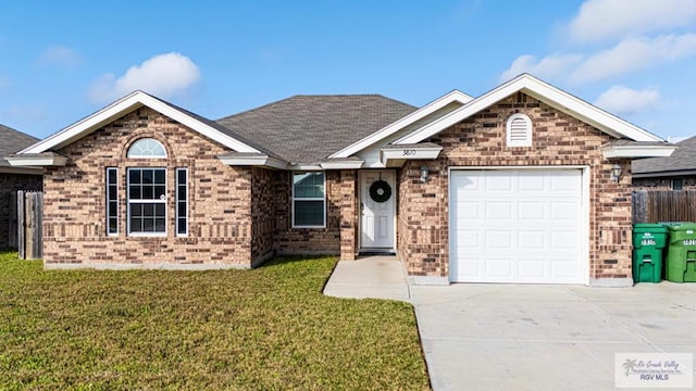 view of front of property featuring a garage and a front yard