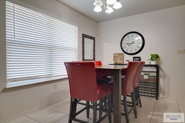 dining room with an inviting chandelier and light tile patterned floors