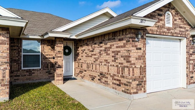 doorway to property featuring a garage