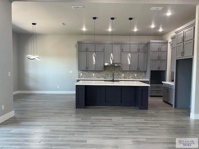 kitchen with pendant lighting, gray cabinetry, and sink