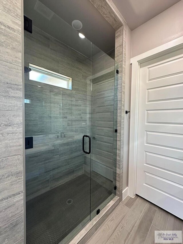 bathroom with a shower with shower door