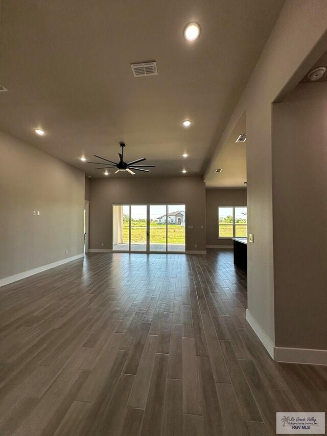 spare room with dark hardwood / wood-style floors and ceiling fan