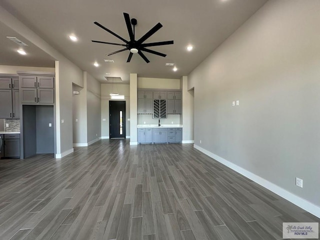 3406 Kelsey Ct, Harlingen, TX 78550 - unfurnished living room with wood finished floors, ceiling fan, and recessed lighting