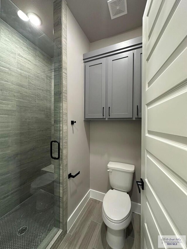 bathroom with toilet and walk in shower