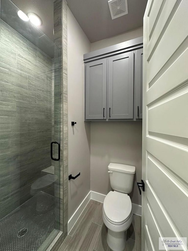 3406 Kelsey Ct, Harlingen, TX 78550 - bathroom with a stall shower and wood tiled floors