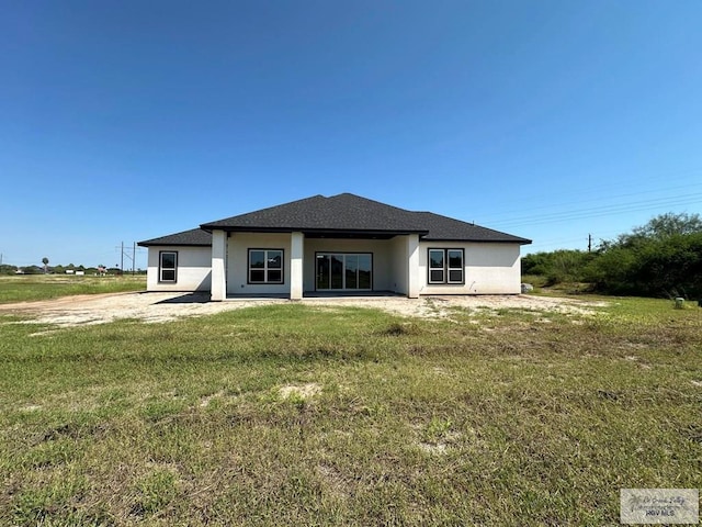 3406 Kelsey Ct, Harlingen, TX 78550 - back of house featuring stucco siding and a lawn