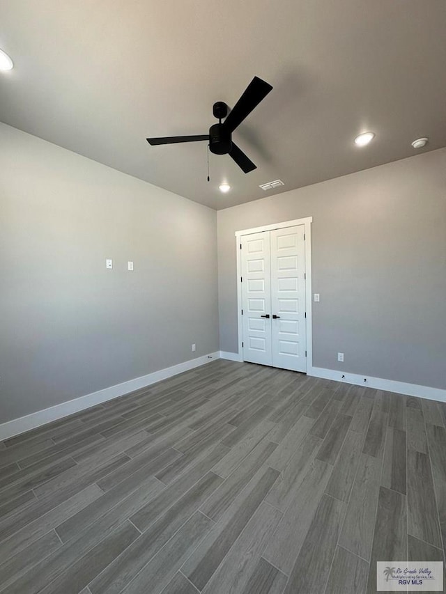 3406 Kelsey Ct, Harlingen, TX 78550 - unfurnished bedroom featuring dark wood-type flooring, recessed lighting, ceiling fan, and a closet