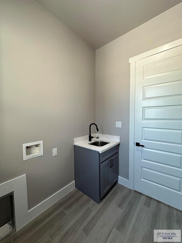 laundry room with sink, cabinets, hookup for a washing machine, and dark hardwood / wood-style floors