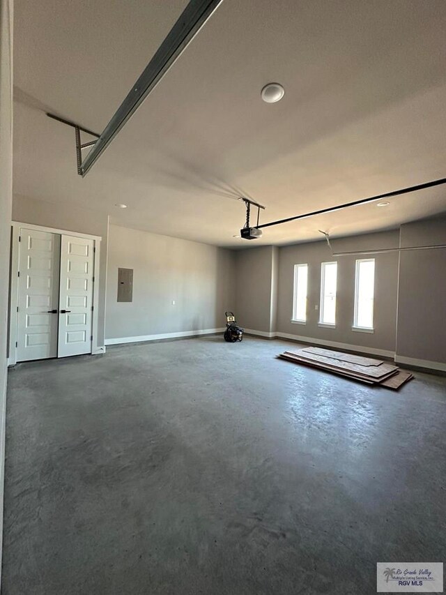 garage with a garage door opener and electric panel