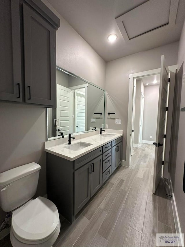3406 Kelsey Ct, Harlingen, TX 78550 - full bathroom featuring wood finished floors, double vanity, and recessed lighting