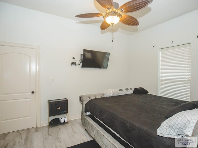 bedroom with ceiling fan and light hardwood / wood-style floors