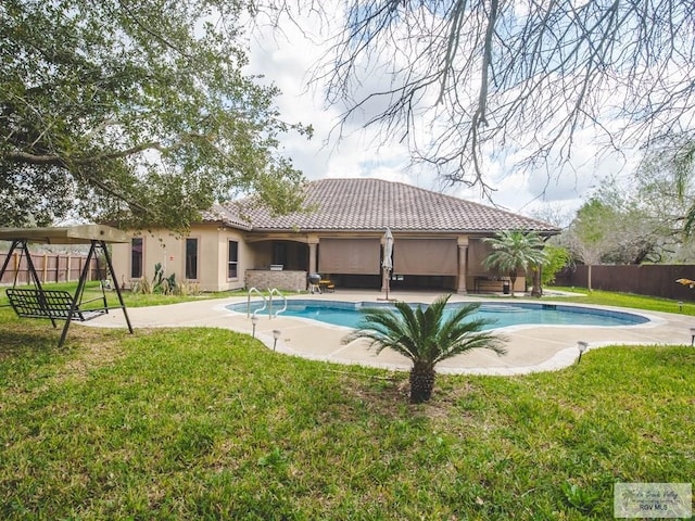 view of pool featuring a yard and a patio