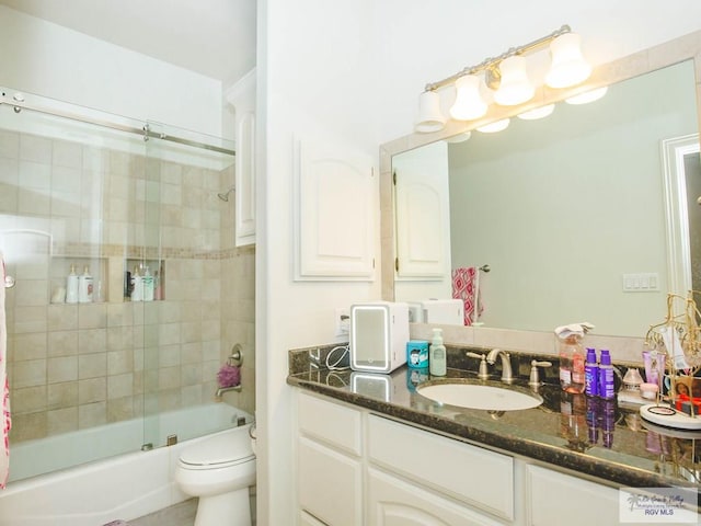 full bathroom featuring vanity, toilet, and enclosed tub / shower combo