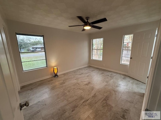 empty room with plenty of natural light and ceiling fan