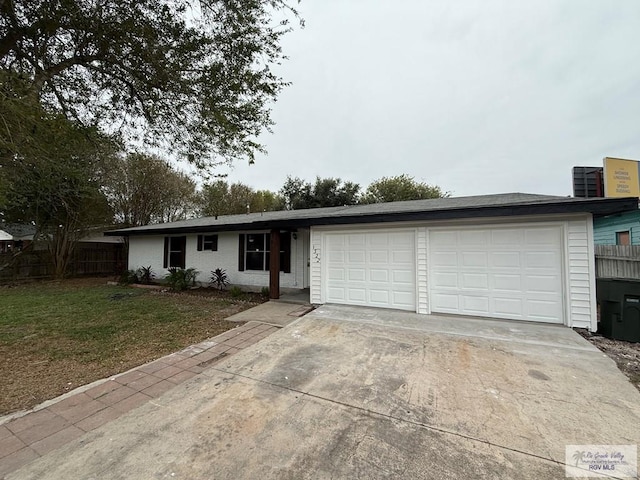 single story home with a garage and a front lawn